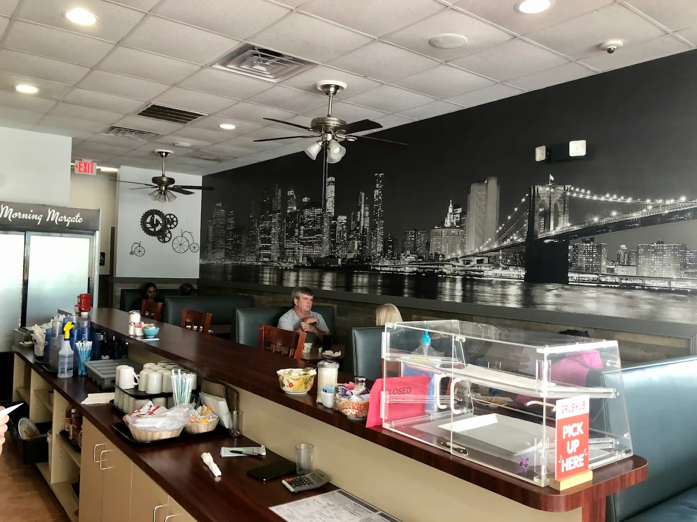 Inside Toasted Cafe — dining room with New York City mural