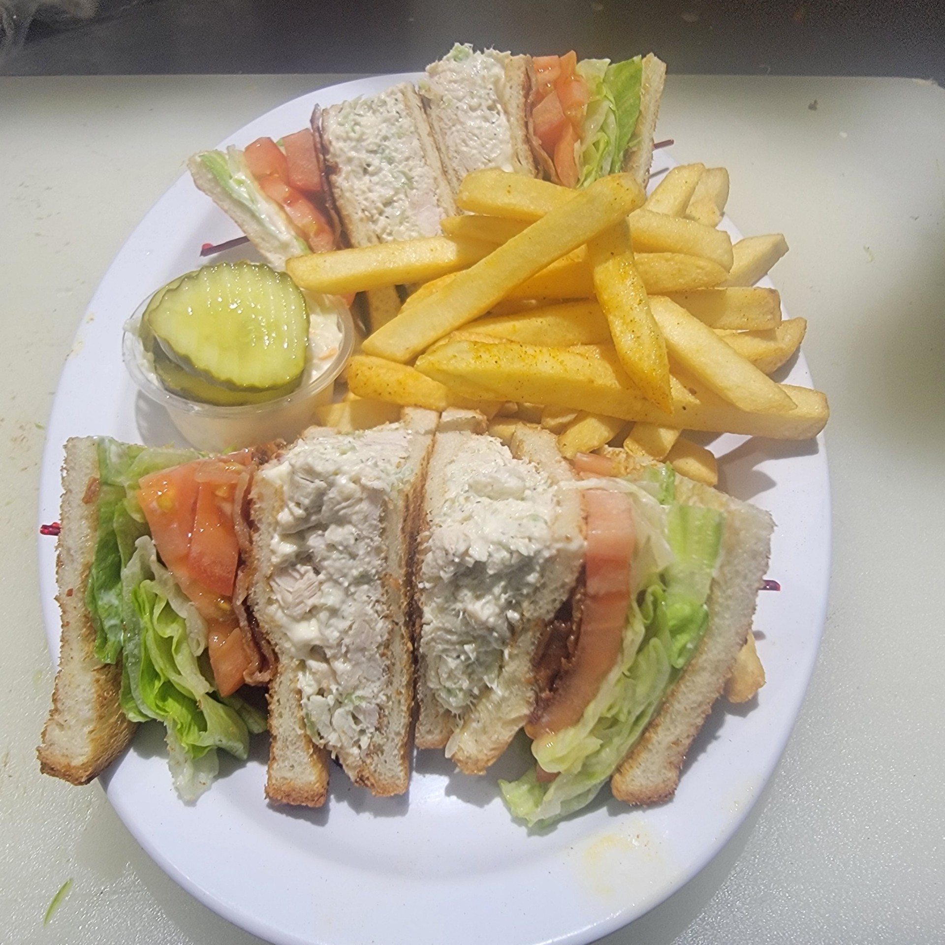 Chicken salad club sandwich with fries