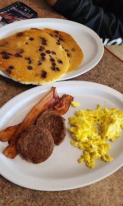 Chocolate chip pancakes served with eggs, bacon and sausage